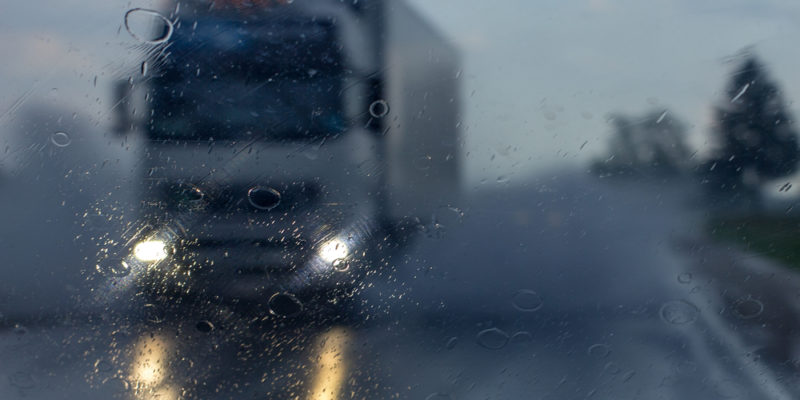 Truck on wet rainy freeway